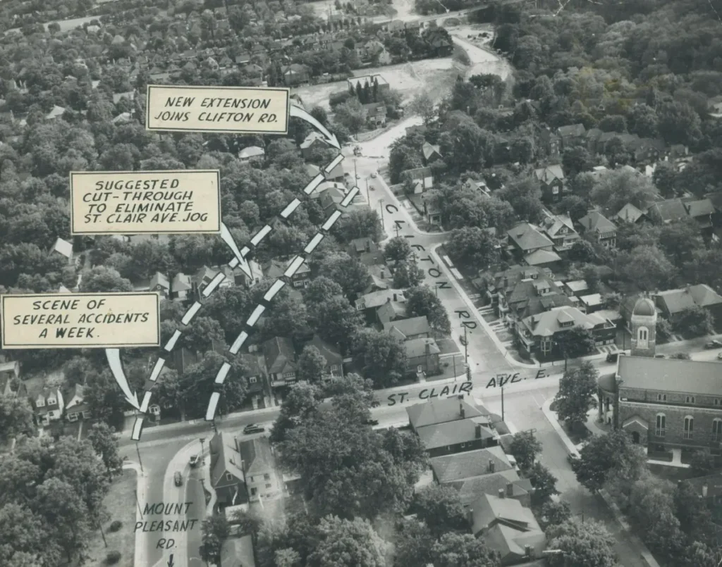 Aerial photograph of a wooded neighborhood marked with dashed lines and labels including &ldquo;AIR OBSERVATION,&rdquo; &ldquo;SUGGESTED CUT-THROUGH,&rdquo; and &ldquo;SCENE OF SEVERAL ACCIDENTS A WEEK.&rdquo;