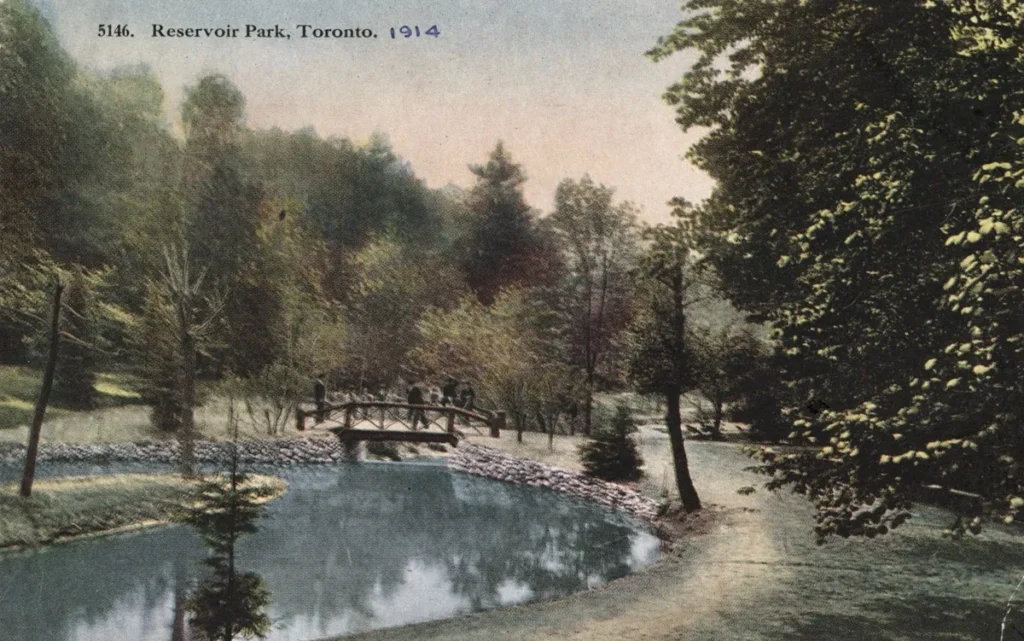 Postcard depicting a pond and footbridge at Reservoir Park, Toronto, in 1914.