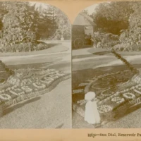 Stereoscopic sepia photograph of a woman beside an elaborate sand design, with handwritten notes and a printed caption along the borders.