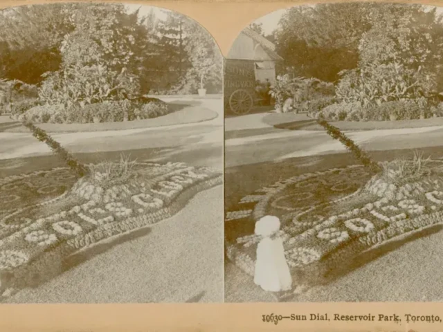 Stereoscopic sepia photograph of a woman beside an elaborate sand design, with handwritten notes and a printed caption along the borders.