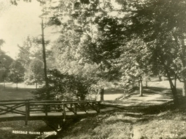 Sepia photograph of a wooded park with a rustic fence and a small caption reading “Rosebud Fishing Tr…”