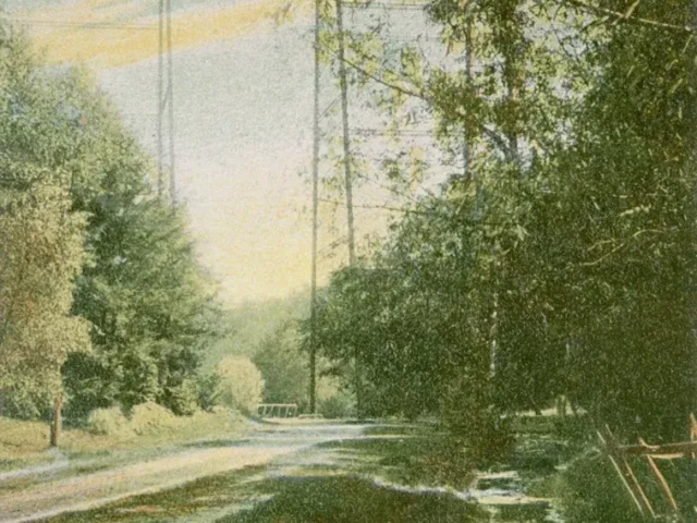 A watercolor landscape depicts a river winding through trees beneath a tall suspension bridge, with faint text along the bottom.