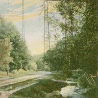 A watercolor landscape depicts a river winding through trees beneath a tall suspension bridge, with faint text along the bottom.